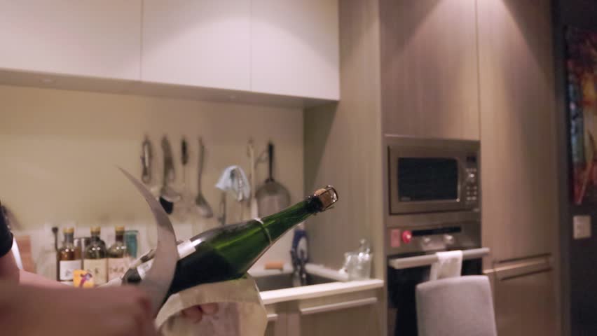Champagne bottle being sabered, bottle pop, celebration, cork pop. HD 24FPS