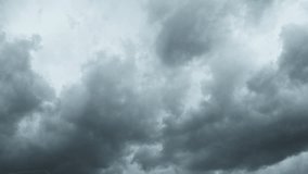 Gray clouds. Puffy fluffy dark clouds. Cumulus cloudscape real time footage. Autumn or winter sky 4k video. Nature weather forecast. Rainy cloud background. Cloudy dramatic storm. Hurricane or cyclone
