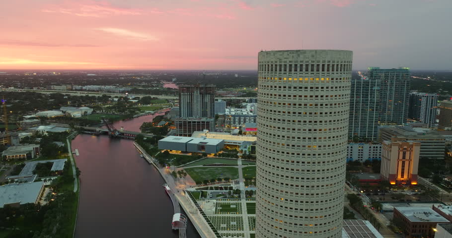 Downtown district of Tampa city in Florida, USA at sunset with brightly illuminated high skyscraper buildings. American travel destination