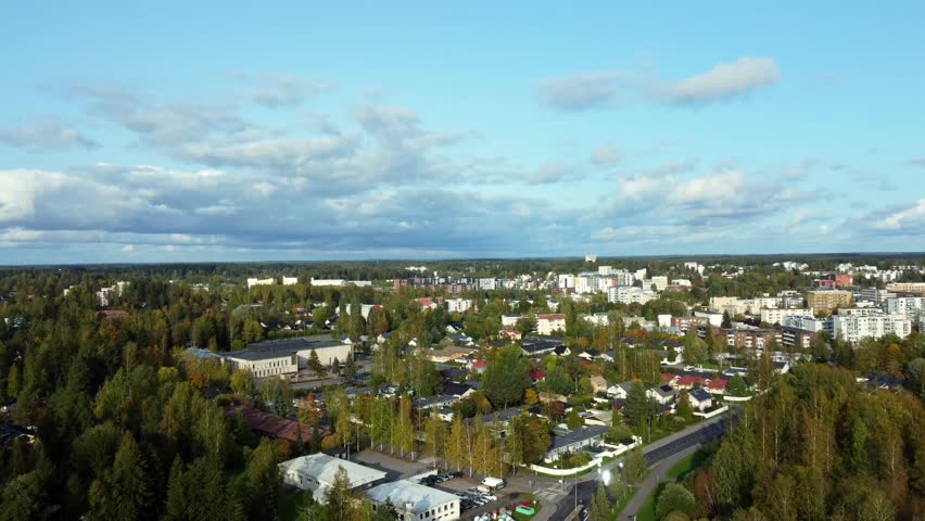 Aerial view establishing the rural town of Kerava in southern Finland, quiet town on a sunny day with clouds on the horizon.