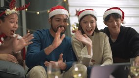 close up face of asian young teen calling through screen tablet to friends. party of people celebrating by technology online communication. friend female and male celebrating christmas at home.