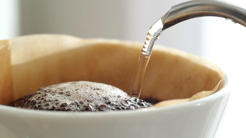 Making hand drip coffee. Slow motion of Pour boiling hot water flows out of the spout of the drip pot, Close-up. Steam rises from the ground coffee beans. Morning sunlight | Shutterstock HD Video #1110793877