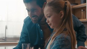 Caucasian father help online task internet homework little girl pupil school child daughter together e-learning studying knowledge distant education study learning using computer laptop at kitchen - Powered by Shutterstock - Get 15% off with code: PIKWIZARD15