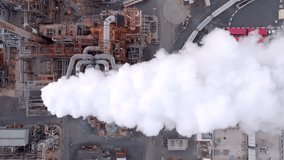 Chimney full of puffy smoke clouds. 4k aerial drone footage overhead