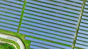 Precision-engineered solar farm captured from above by a drone, solar modules aligned perfectly to maximize energy capture. Sustainable, eco-friendly: Embrace Renewable Energy.
