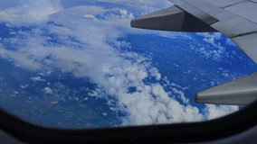 4K video aerial view of the cloudscape through an airplane window, vibrant natural scenery. Travel concept, traveler, trip, vacation, tourism, landscape. Background footage