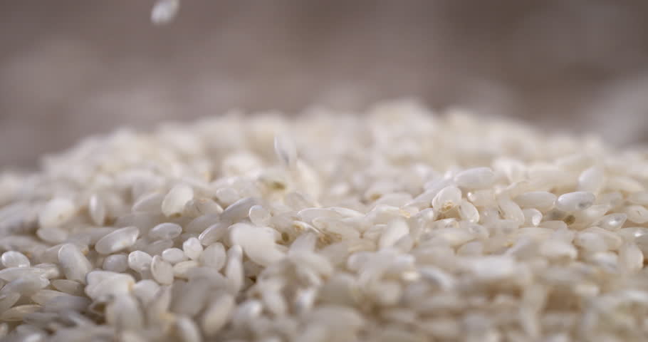 Super slow motion macro of dry basmati quality rice falling on rustic wooden table on restaurant kitchen. Macro, 4K, ,Very Close-up, 1000 fps video. Royalty-Free Stock Footage #1110807451