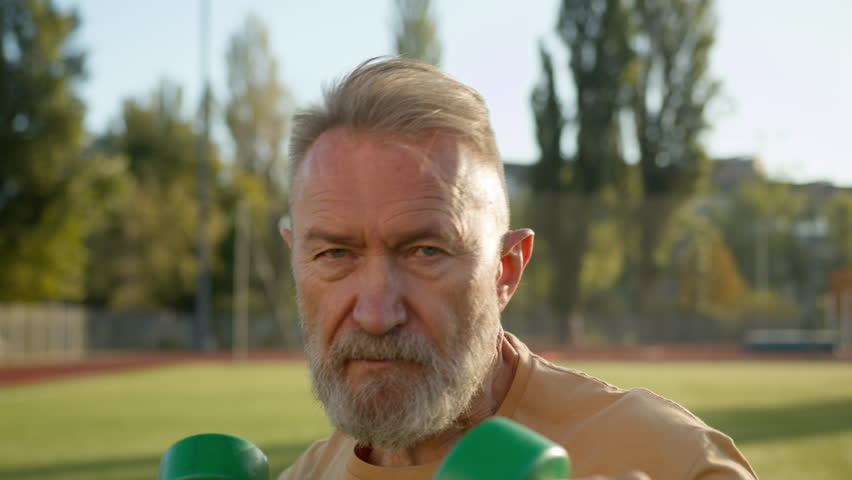 Confident old Caucasian man workout dumbbells weight arm training sport sportsman bodybuilder strength exercising physical athlete strong equipment muscular power vitality stadium city outdoors effort Royalty-Free Stock Footage #1110811887