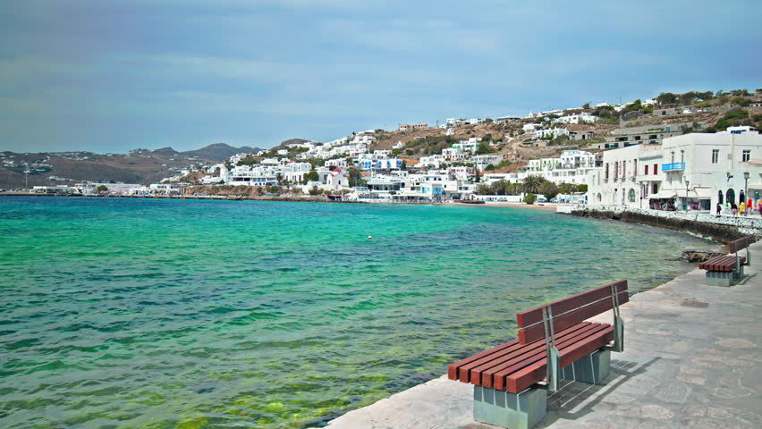 Panoramic view of whitewashed traditional houses in Mykonos on the Aegean Sea. Famous turquoise clear water beach and luxury resorts, island of Mykonos, Cyclades, Greece.