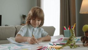 Adorable kid engrossed in drawing, bringing his vibrant ideas to life on paper. With every stroke of pencil, his childlike creativity and artistic potential shine brightly, passion for children's art