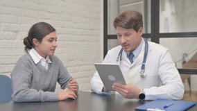 Middle Aged Doctor Discussing Medical Report with Indian Woman