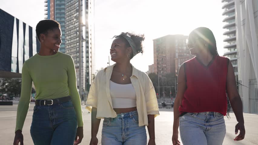Team of three African American girl friends walking together with confidence and determination towards their goal - Group of young confident black women