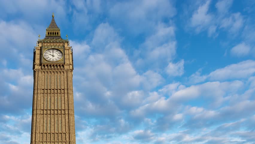 The famous Big Ben, or Elizabeth clock tower, in London, England. One hour time lapse with white clouds passing by behind. Copy space for text, image or logo on the side. | Shutterstock HD Video #1110826599