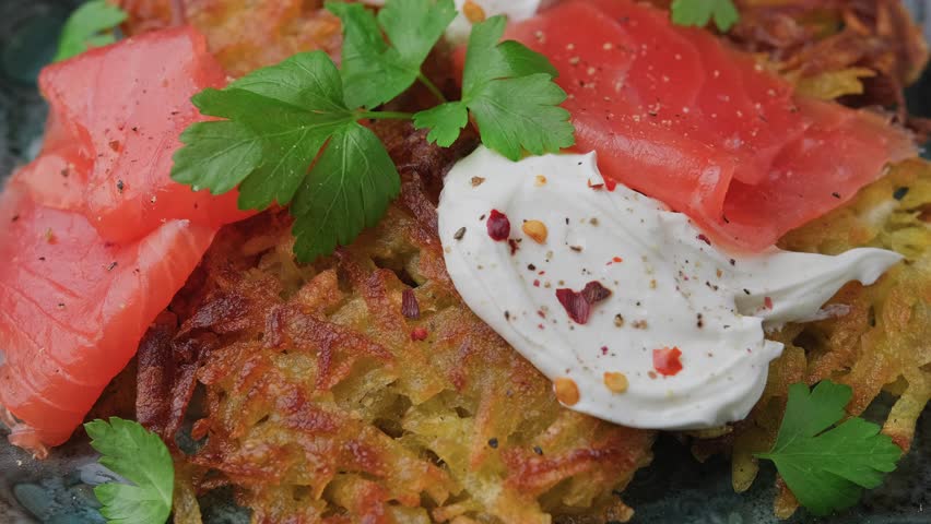 Potato rosti with smoked salmon and soft cheese. Rotating video