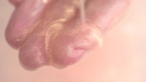 Moisturizing lotion with shimmer pouring into open hand and flows from the fingers. Skin care concept - Powered by Shutterstock - Get 15% off with code: PIKWIZARD15