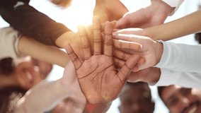 Young happy people put their hands together. - Powered by Shutterstock - Get 15% off with code: PIKWIZARD15