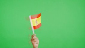 Hand waving a pennant of a spanish national flag