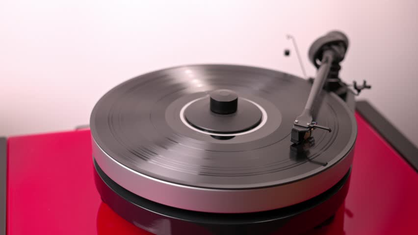 Сlose-up view of person's hand as they turn off playing vinyl record on turntable by gently lifting tonearm. | Shutterstock HD Video #1110837177