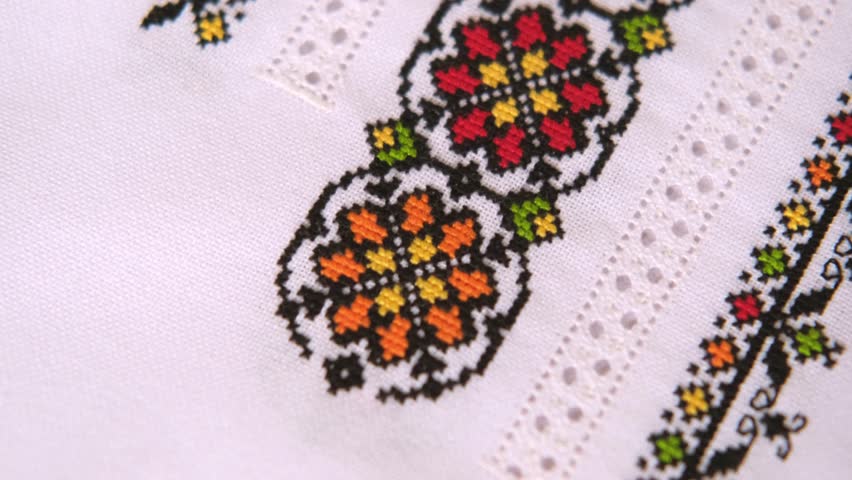 Slavic cross stitch by colored cotton threads. Design of ethnic pattern with cross stitch and hemstitch technique. Background with Embroidery Texture.