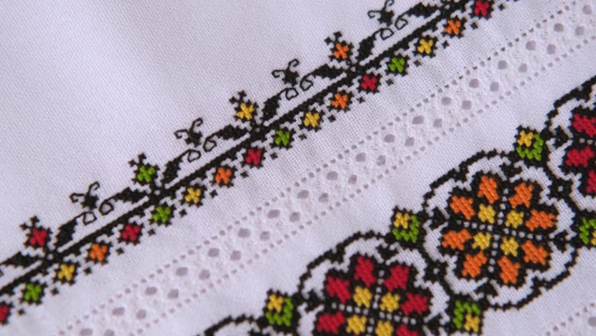 Slavic cross stitch by colored cotton threads. Design of ethnic pattern with cross stitch and hemstitch technique. Background with Embroidery Texture.