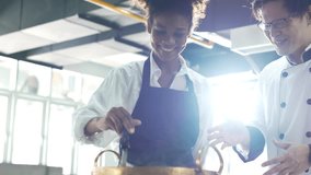 Medium Shot. Asian restaurant kitchen. Chef fries food on a pan, Seasons it and flips cutlet. Cooking delicious and traditional authentic food. Chinese food dishes. - Powered by Shutterstock - Get 15% off with code: PIKWIZARD15