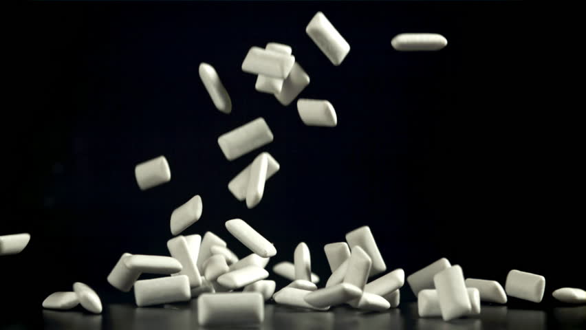 Chewing gum falls on a black table. Filmed on a high-speed camera at 1000 fps. High quality FullHD footage