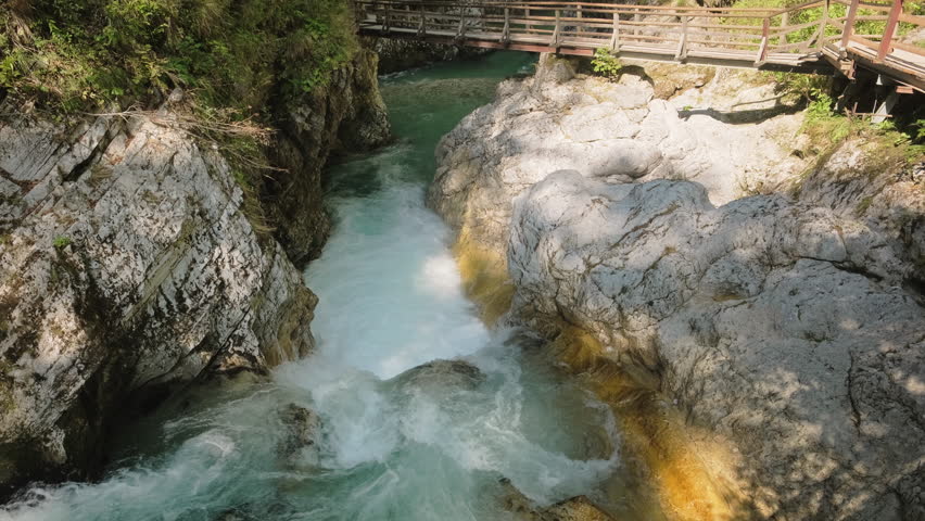 The Vintgar Gorge in Triglav National Park, Slovenia, is a stunning canyon with turquoise river water near Bled. It's known as Soteska Vintgar or Blejski Vintgar in Triglavski narodni park.  Royalty-Free Stock Footage #1110861275
