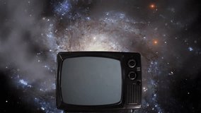 A Spiral Galaxy and Vintage Television Turning On Green Screen. Elements of this Video furnished by NASA. 4K Resolution.