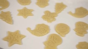 Christmas cookies are prepared for baking. Cheerful Santa Claus snowflake and Christmas tree look delicious. Wiring top view Christmas cookies making process. Christmas traditions concept. Home baking - Powered by Shutterstock - Get 15% off with code: PIKWIZARD15