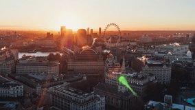 Aerial View Shot of London UK, United Kingdom, City Center, Southbank, day, rising sun, flares, London Eye