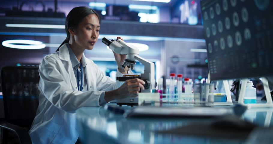 Medical Research And Development Center: Female Asian Scientist Using Microscope To Analyze Petri Dish Sample. Specialist Developing Innovative Medicine For Treating Mental Disorders Or Pain Relief. Royalty-Free Stock Footage #1110879567