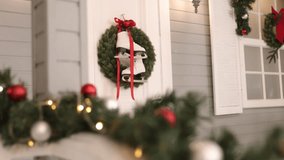 Outdoor view, Frosty decor, Garland decoration. Ice skates dangle from door of snow-hued residence, framed by soft glow of strung-up garland lights. - Powered by Shutterstock - Get 15% off with code: PIKWIZARD15