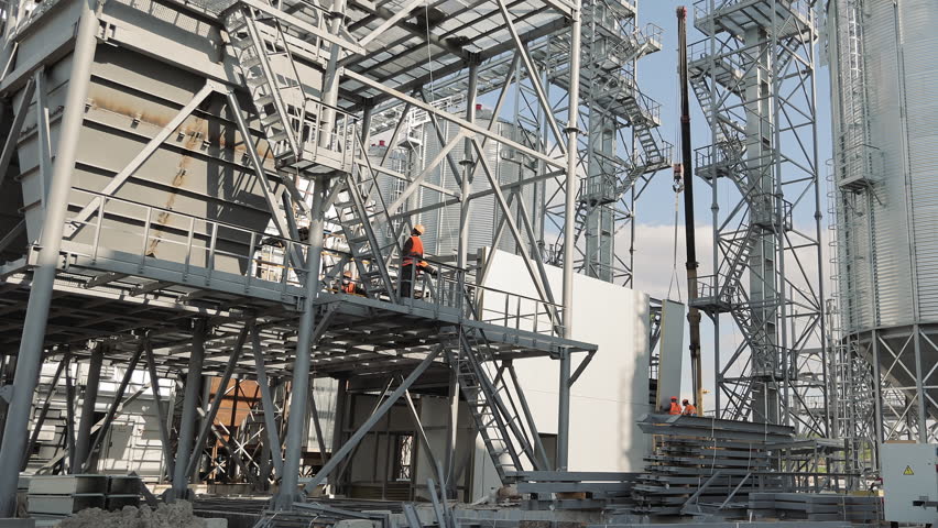 Metal structures of the gas production station and workers inspecting and preparing the station for the winter heating period. Repair and construction works on metal constructions
