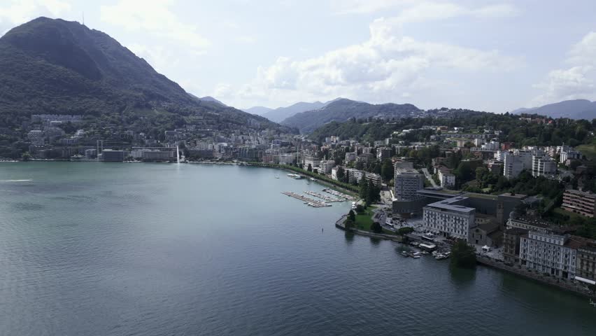 Aerial view of Lugano, Switzerland city center lakefront of Lake Lugano. Monte San Salvatore in the background. Stunning scenery and nature, beautiful buildings.