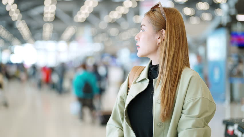 Happy woman friends holding passport and luggage walking together to airline check in counter in airport terminal. Attractive girl enjoy and fun travel on holiday vacation with airplane transportation | Shutterstock HD Video #1110901857