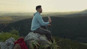 Hiking, view of mountain and man drinking water, relax on outdoor adventure and freedom in nature. Trekking at sunset, rock climbing and hiker sitting with bottle, horizon and motivation to travel. - Powered by Shutterstock - Get 15% off with code: PIKWIZARD15