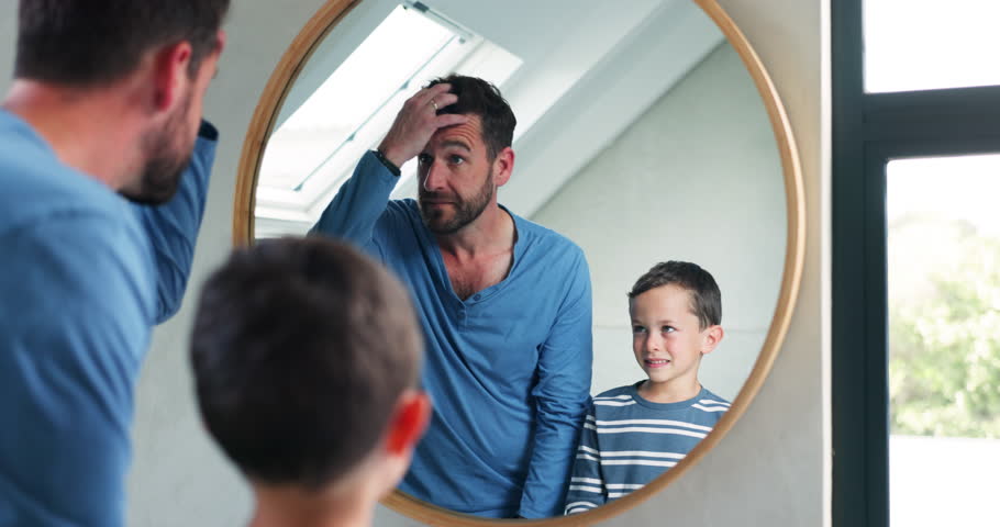 Hair, bathroom mirror and a father and child at home for hairstyle, imitate or self care. A happy man and a boy kid together in a family house for grooming, hygiene or happiness motivation in morning
