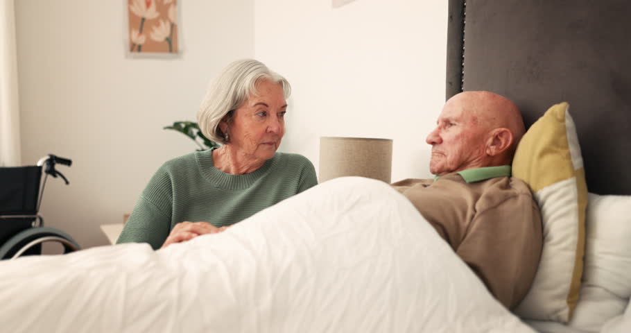 Bed, sick and senior couple holding hands for support, bonding and compassion at home together. Retirement, marriage and elderly woman care for man in bedroom for illness, healing and recovery