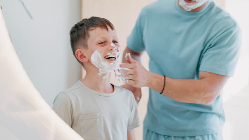 Man, child and shave learning in mirror for clean face, hygiene or masculine grooming practice. Male person, son and soap cream for health connection or childhood joy in bathroom, smooth or care foam Royalty-Free Stock Footage #1110916111