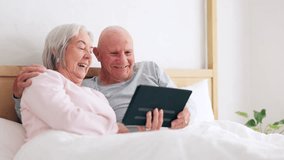 Senior, happy couple and tablet for fun in bedroom with social media, post or meme on app. Elderly woman, man and married with laugh for joke by scroll, browse or reading on internet with connection - Powered by Shutterstock - Get 15% off with code: PIKWIZARD15