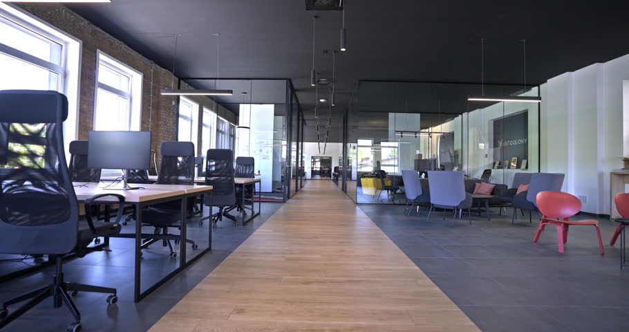Modern startup centers composed of glass offices within a contemporary corporate environment, highlighting the sleek, innovative, and minimalist design aesthetics of a cutting-edge workspace Royalty-Free Stock Footage #1110917693