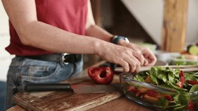 girl cooking and mixing a vegetable salad in the bowl in the kitchen, concept of healthy food - Powered by Shutterstock - Get 15% off with code: PIKWIZARD15