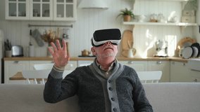 Excited mature senior man wearing using virtual reality metaverse VR glasses headset at home. Grandfather touching air during VR experience on virtual reality helmet. Simulation hi-tech videogame - Powered by Shutterstock - Get 15% off with code: PIKWIZARD15
