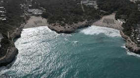 Majorca. Spain. Aerial view, waves break on two small coves. Slow motion 4K