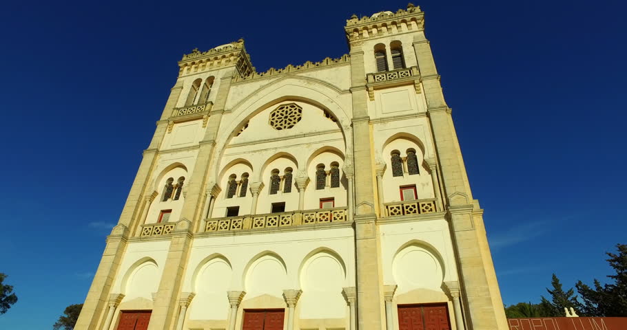 Panning Shot Of Low Angle View Of Famous Saint Louis Cathedral Against Blue Sky On Sunny Day - Mahdia, Tunisia Royalty-Free Stock Footage #1110921533
