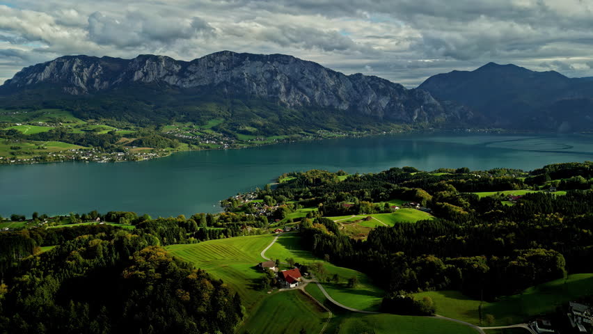 Aerial overview of rural nature and lake Attersee, fall day in Austria