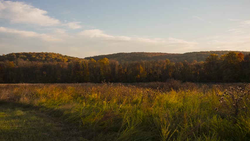 Autumn timelapse in nature with clouds passing by from wide shot of valley