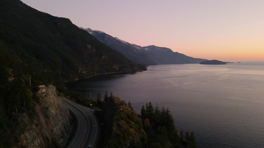 Sea to Sky Highway on West Coast of Pacific Ocean. Aerial Mountain Landscape. Twilight sky. Howe Sound, BC, Canada. Royalty-Free Stock Footage #1110935779