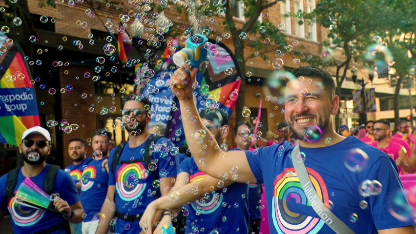 Orlando, FL - October 21, 2023:  Thousands of happy people sing, dance, and march through the streets of Orlando as they participate in the annual LGBT Pride Parade.