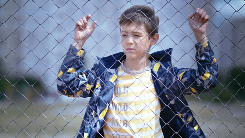 Contemplative Pause: Reflective Boy Gathers Strength to Face the Camera